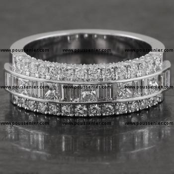 ring with baguette and princess cut diamonds chanel and flanked on both sides and rims by castle set brilliant cut diamonds