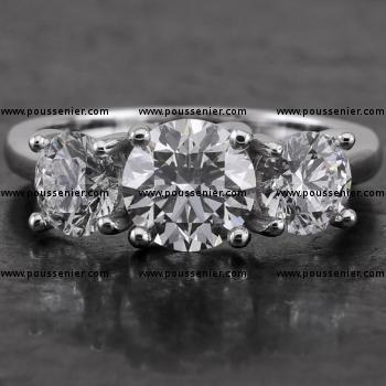 trilogy ring with a central larger diamond flanked by two large diamonds set with four crossed prongs