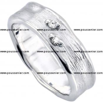 wedding ring with two brilliant cut diamonds on a capricious band with organic borders