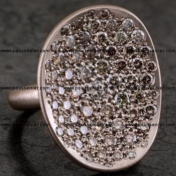 pavé ring with a concave asymmetric disc or bowl with pavé set fancy brown brilliant cut diamonds mounted on a narrow band