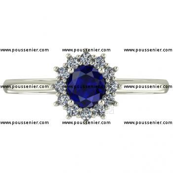 halo or entourage ring with a central slightly oval sapphire surrounded by brilliant cut diamonds with intermediate prongs and mounted on a band with palmettes
