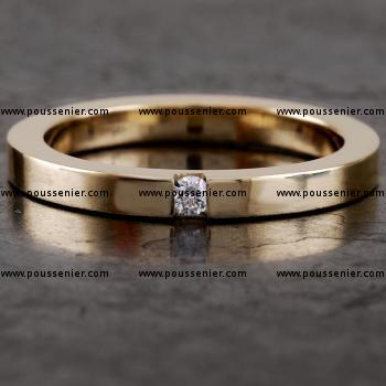 sleek, fine wedding ring with a rectangular profile and a brilliant cut diamond