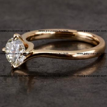 handmade solitaire ring with a brilliant cut diamond in a twisted setting with four prongs with a slightly straighter conveyor shank