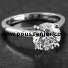 solitaire ring with a brilliant cut diamond set with four prongs on a thinner slightly rounded band with palmets