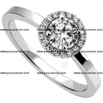 halo ring with a central brilliant cut diamond surrounded by smaller diamonds on a slim band
