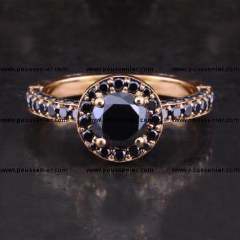 halo ring with a central brilliant-cut black diamond surrounded by smaller black diamonds pavé set with an engraved border