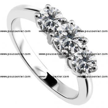 trilogy ring with a brilliant cut diamond of a half carat diamonds in the middle and two of thirty points aside