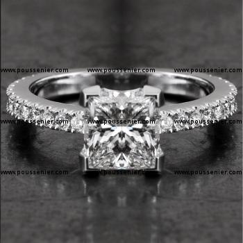 solitaire ring with a central princess cut diamond flanked by castle-set brilliant-cut diamonds on the slim band